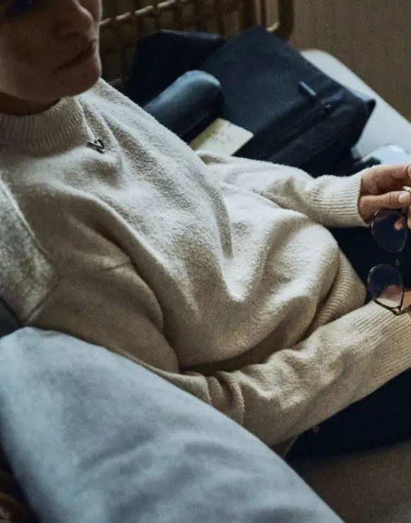 Guest in a cozy sweater relaxing in a lounge chair