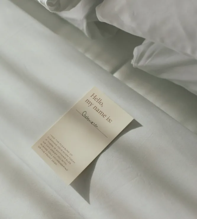 Handwritten welcome card on a bed