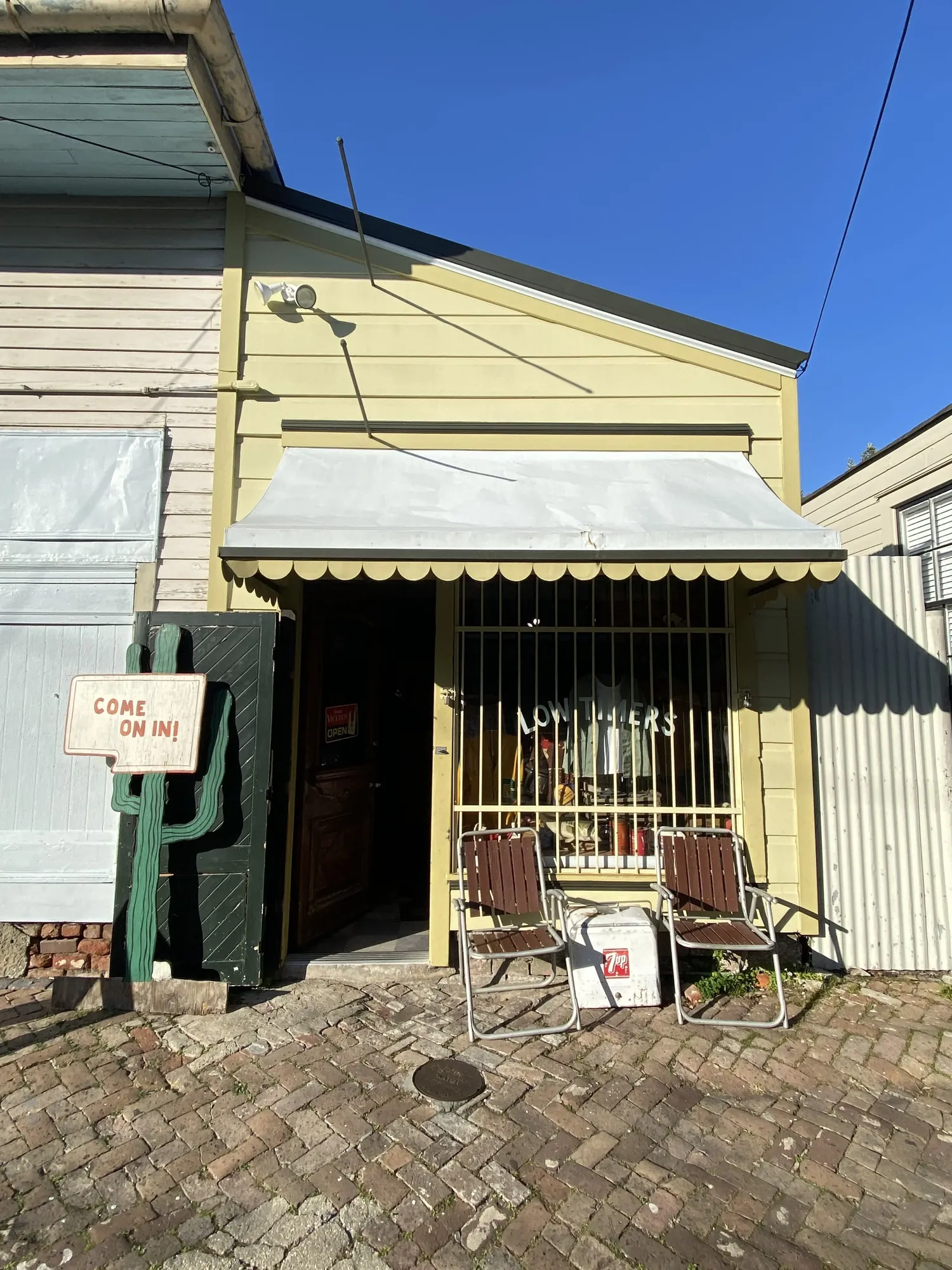 Small yellow house with a cactus by the door
