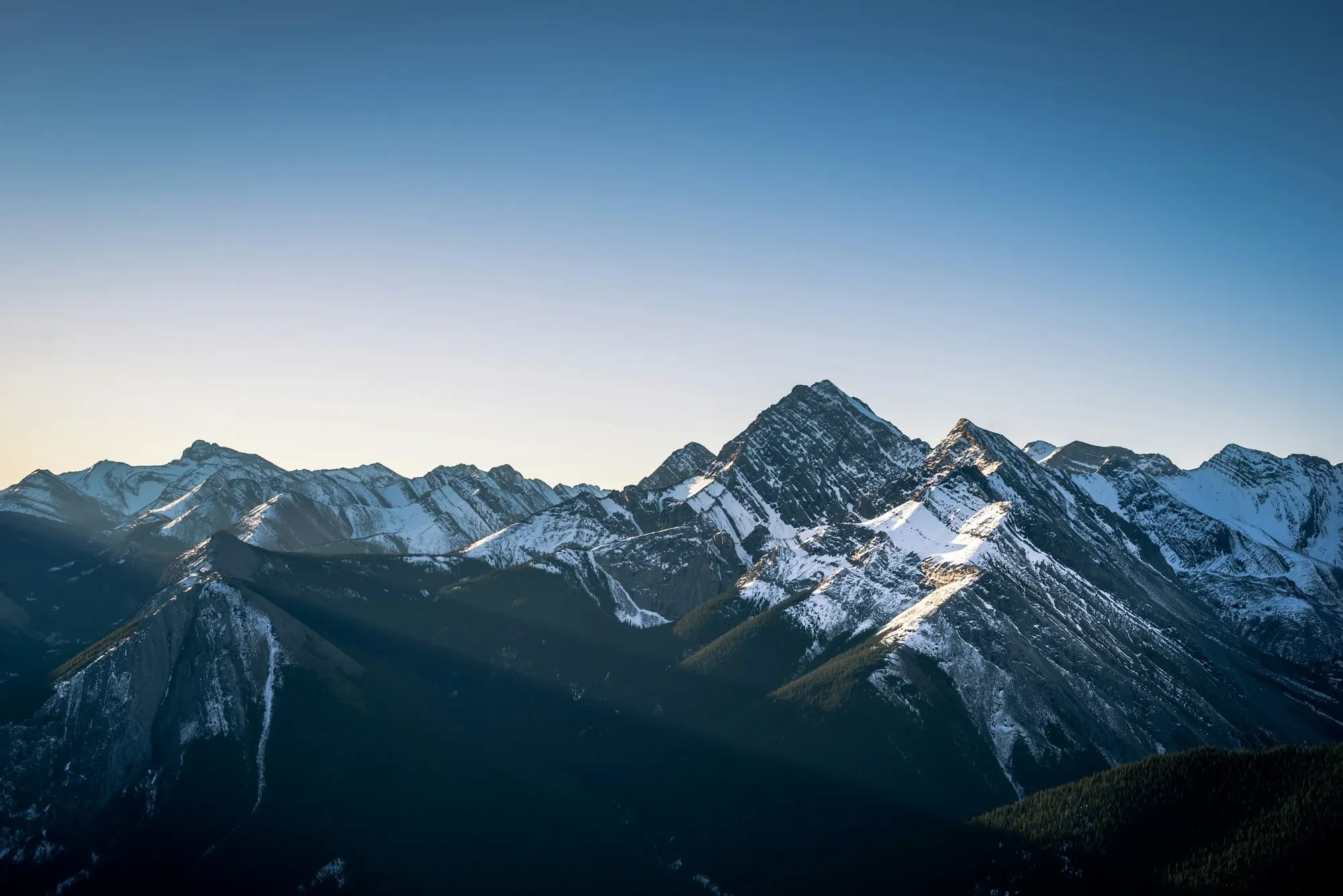 Snow-capped mountain peaks at dusk