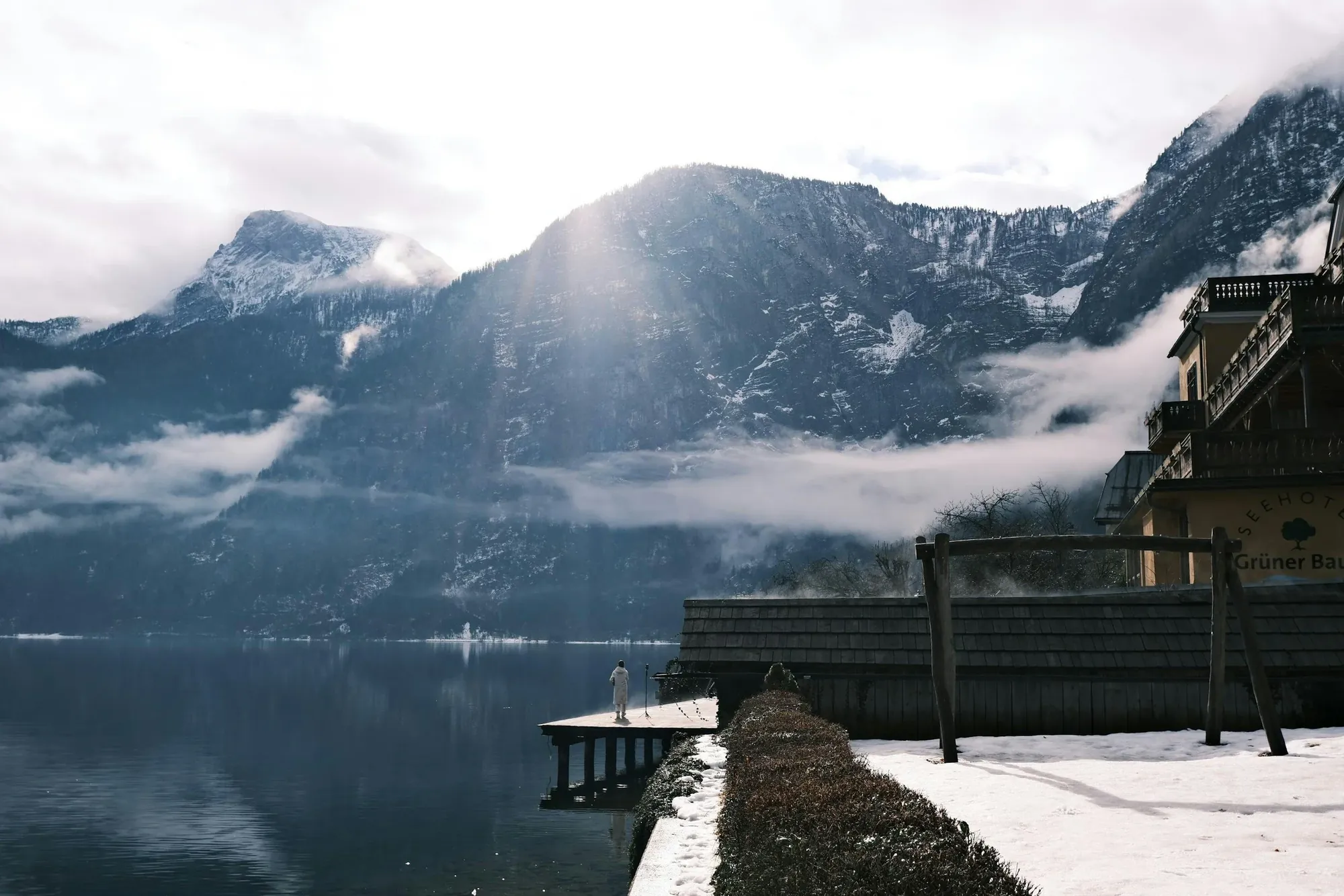 Misty mountains above a lake from a snowy terrace