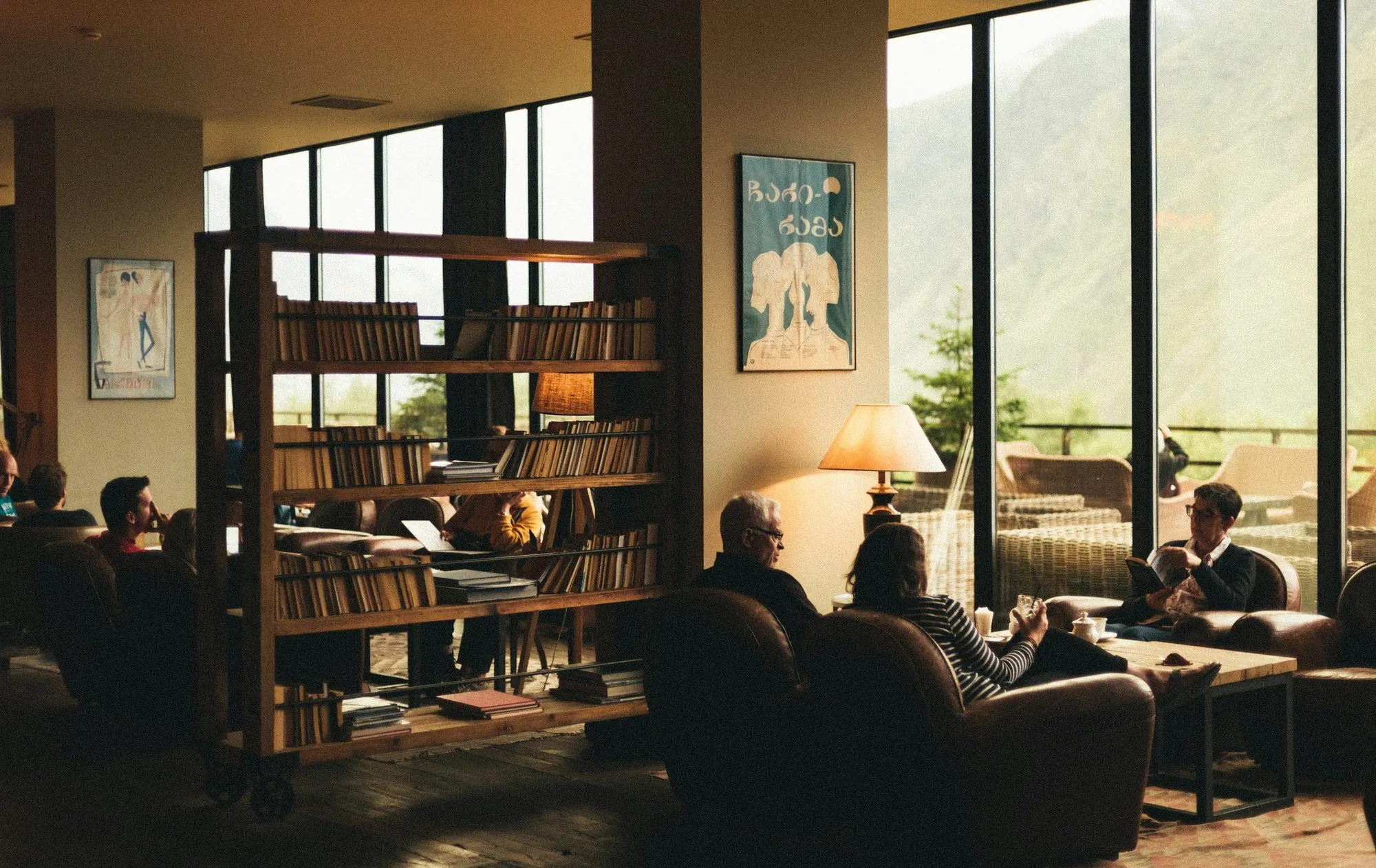 Guests reading in a hotel library lounge