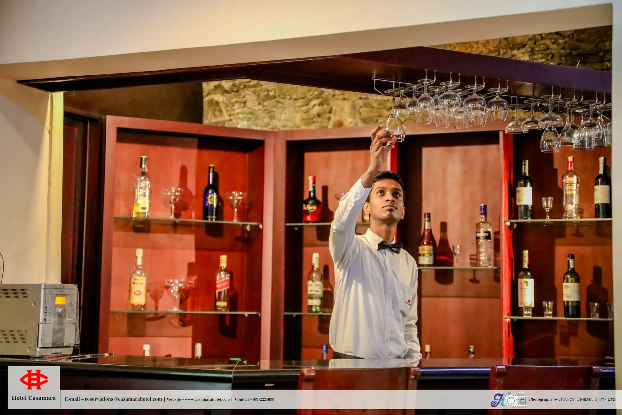 Bartender reaching for a glass at a hotel bar