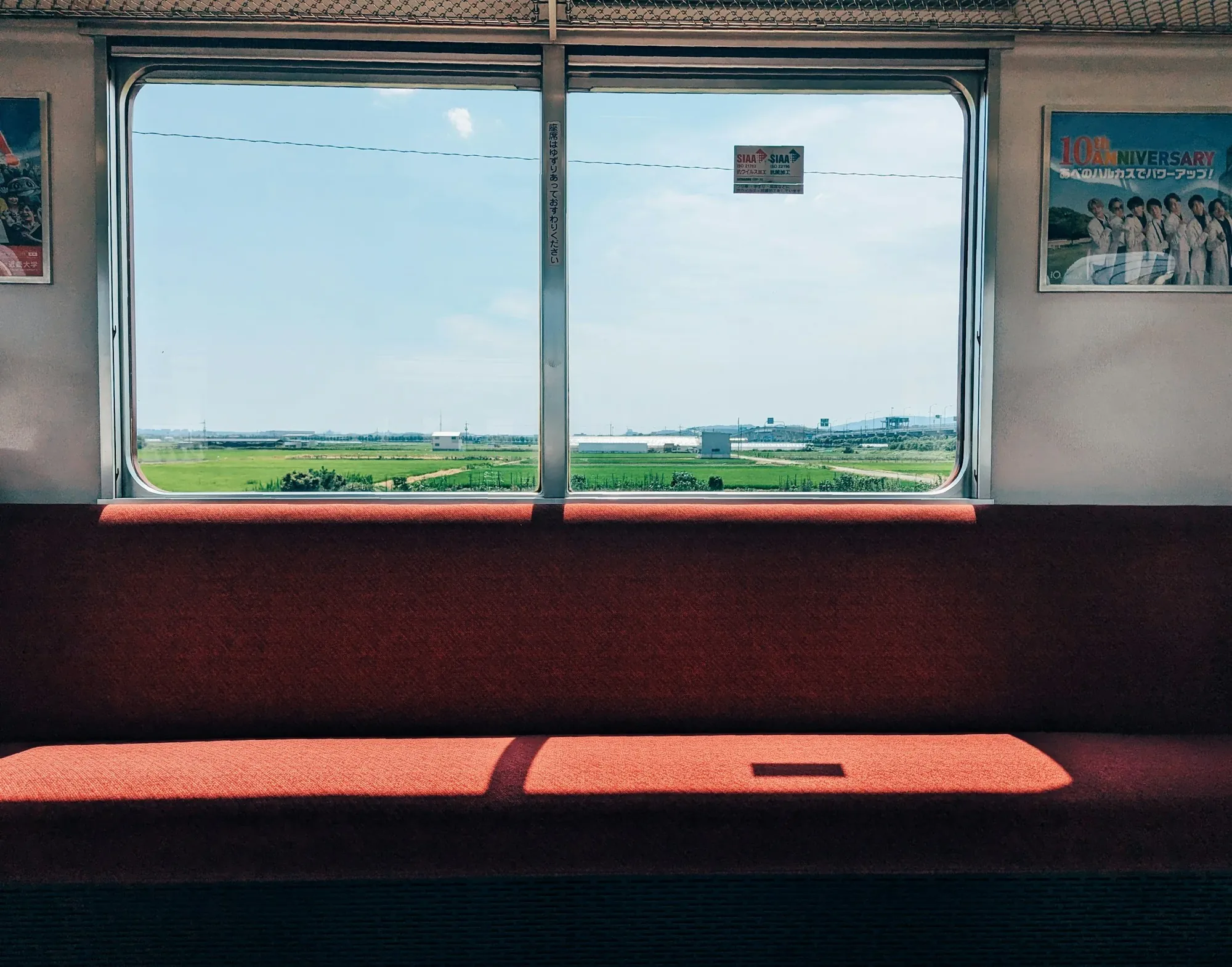 Train window looking out over green fields