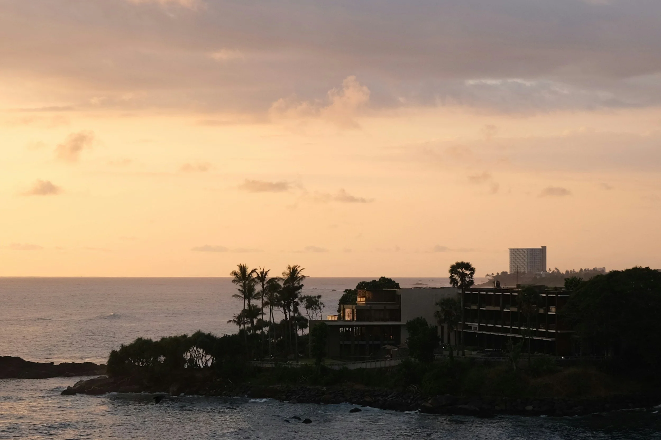 Coastline silhouetted at sunset