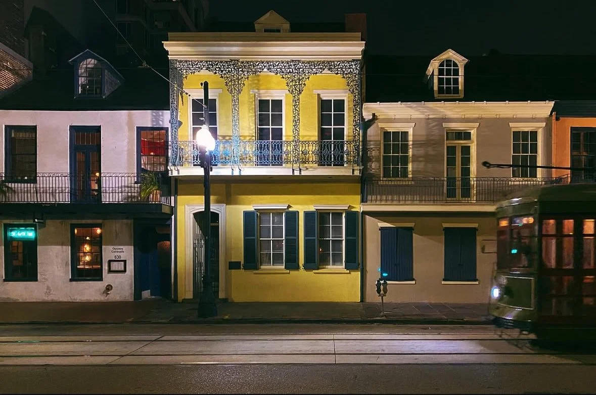 New Orleans street at night with streetcar